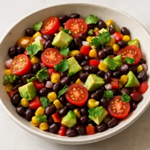 Black bean and corn salad with cherry tomatoes, red pepper, cilantro, and avocado